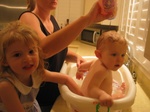 Paige is helping mom give Josie a bath!