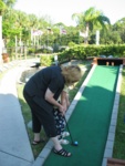 Okay, here we go - Gramma shows Paige how to properly hit the ball with the club.