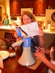 Here she is reading the manual on the Megaphone -- the rest of the night she ran around saying "Pull over - you're driving tooo slow!" haha!