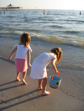 Josie and Paige collecting shells.