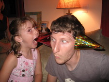 Oh my, now Paige is biting Mark's party hat/ear?