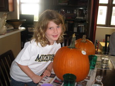 Paige-E's ready to roll - she picked one of the big pumpkins.