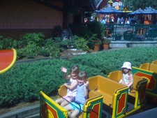 Paige & Josie wave from the train in Downtown Disney.